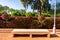 Bench in front of Flowering Plants at Cyber Park in Marrakesh Morocco