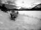 Bench at the frozen Vermillion Lake surrounded by Canadian Rocky Mountains.