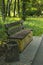 Bench, garbage container, asphalt path in the park