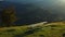 Bench green mountains nobody sit against impressive rocky landscape sunlights