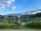 Bench looking at a tranquil lakeside scenery with a parish church and castle in Goldegg, Austria