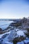 Bench on Marginal Way path along the rocky coast of Maine in Ogunquit during winter