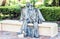 Bench with metal sculpture of a man and a woman in Parco Colonna, famous public park in Taormina, Sicily, Italy