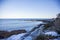 Bench n Marginal Way path along the rocky coast of Maine in Ogunquit during winter