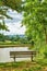 A bench overlooking a lake in the countryside, surrounded by farmland and a forest close to Lyon, France. A quiet place