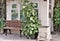 A bench in a park and a potted plant near garden keeper`s house