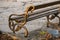 Bench in the park at sunset with metal railing in the form of a snake or a dragon in Austria.