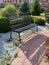 Bench and path, bushes in summer garden