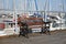 Bench on pier where sea yachts dense parking in calm marina water