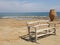 A bench and a pot on the seashore