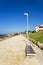 Bench on the promenade along the Mediterranean coast with Hotels