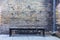 Bench and a rain pipe in a dark corner