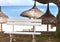 Bench for rest under a straw sunshade on the seashore. Mauritius