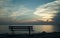 Bench by the sea at sunset