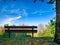 Bench in the shade of trees overlooking the landscape