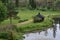 A bench and a shed along the pathway near a lake