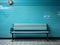 a bench sitting in front of a blue tiled wall