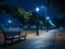 a bench sitting on a sidewalk at night