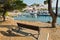 Bench at small island with a view of Skiathos town waterfront and harbor, Skiathos island