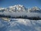 Bench in the Snow with clouds and mountain