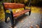 Bench in the summer park with old trees and footpath