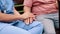 Bench, support or closeup of nurse holding hands with patient for healthcare, wellness and service. Outdoor, love and