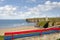 Bench view of Ballybunion beach cliffs and castle