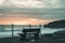 Bench with view of the beach on the north Cornish coast near Bude, England after sunset