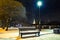 Bench, walkway covered snow and street light at night. Winter cityscape in Saint Petersburg, Russia.