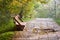 The bench of the wooden pallet stands on the alley of the park