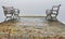 Benches on a jetty on a foggy autumn day.