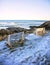 Benches on Marginal Way path along the rocky coast of Maine in Ogunquit during winter