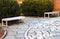 Benches on Patio in Winter Scene With Shrubs Decorated With Tiny LIghts