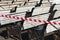 Benches in a public park are in preparation for the coming summer season. The caution tape warns people that benches are still di