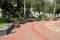 Benches stand in a semicircle in a city park