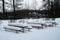 Benches and tables covered with snow