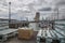 Benches, tables and stools made from recycled wood pallets in a bar in the Lisbon marina near the tower of