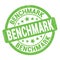 BENCHMARK text written on green round stamp sign