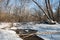 Bend of a creek in winter forest