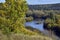 Bend of the Iren river near a high and rocky bank. Sunny autumn in the foothills of the Western Urals.