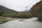 A bend in a mountain river on a cloudy day