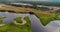 Bend of river aerial view from flying quadcopter over forest.