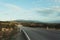 Bending country road with windmills on the hills