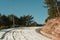 Bending mountain road with snow among the pine trees