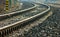 Bending railway with hundreds of pebbles, next to it.