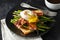Benedict poached Duck egg with crispy bacon and fried asparagus on toasts for breakfast