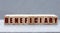 BENEFICIARY - word on wooden bars on a gray background