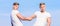 Benefits of having twin brother. Friendship and support. Men muscular twins brothers in white shirts sky background