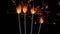 Bengal fires, New Year sparkler candles, sparkling lights burning on a black background, slow motion