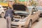 Bengaluru, India June 27,2019 : Businessman trying to insepct his broken car on road side at Bengaluru, India